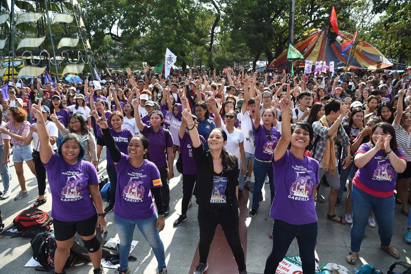 Activists perform the"one billion rising dance during a protest to commemorate International Women's Day in Manila.  AFP