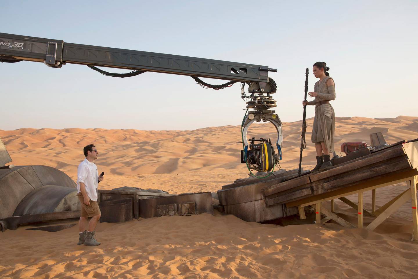 A handout photo of Star Wars: The Force Awakens showing L to R: Director J.J. Abrams w/ actress Daisy Ridley (Rey) on set. (David James / Lucasfilm / Disney) *** Local Caption ***  al07de-starwars7-story.jpg