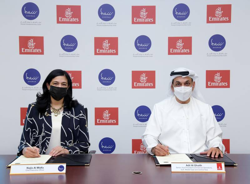 Najla Al Midfa, chief executive of Sheraa, and Adil Al Ghaith, Emirates' senior vice president, commercial operations, Gulf, Middle East and Central Asia, while signing the agreement. Courtesy Emirates