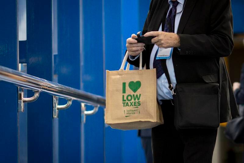 A person attending the conference carries a bag from the Taxpayers' Alliance. EPA