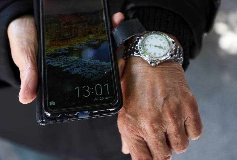 Lebanese man Mohamed Al Arab shows the different times on his watch and mobile phone in Beirut after a controversial government decision to postpone Daylight Saving Time. Reuters