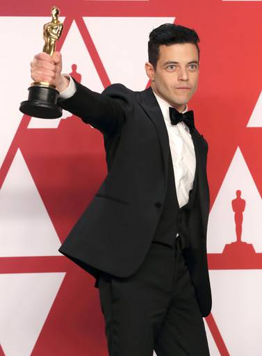 Best Actor Rami Malek poses with his award backstage at the Oscars. Reuters 