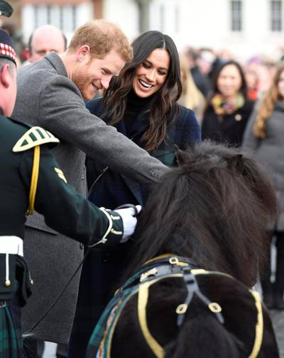 Prince Harry and Meghan Markle meet Pony Major Mark Wilkinson and regimental mascot Cruachan IV during a walkabout on the esplanade at Edinburgh Castle, while on their visit to Scotland.
