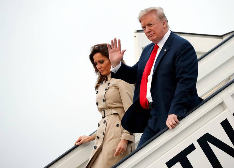 President Donald Trump and Melania Trump walks down the stairs during their arrival on Air Force One at Melsbroek Air Base, Tuesday, July 10, 2018, in Brussels, Belgium. (AP Photo/Pablo Martinez Monsivais)