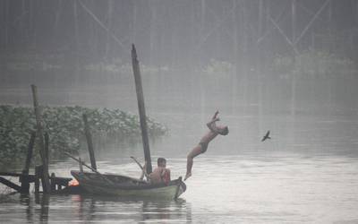 An Indonesian boy jumps into the Siak River amid thick haze in Pekanbaru, Riau  province, Indonesia. Rony Muharran / EPA