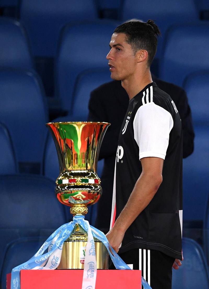 Cristiano Ronaldo looks dejected after the match as he walks past the Coppa Italia after Juventus were beaten by Napoli on penalties. Reuters