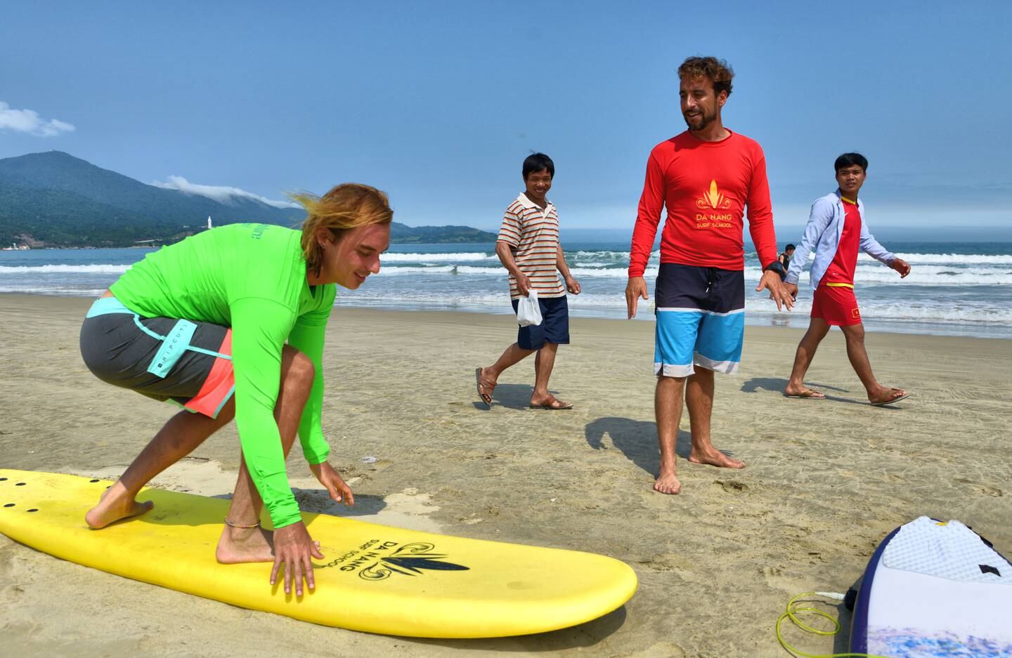 A tourist learns the basics of surfing on China Beach. Photo: Ronan O'Connell