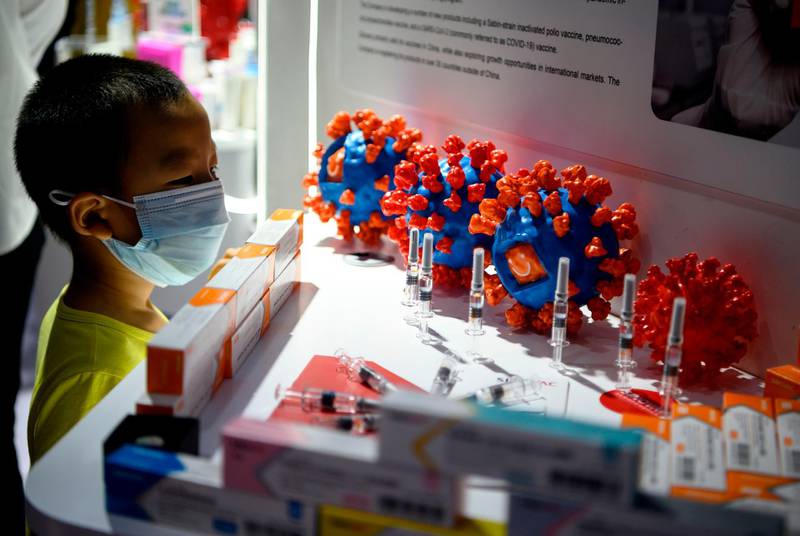 A boy looks at Sinovac Biotech's vaccine candidate at the China International Fair for Trade in Services in Beijing. AFP
