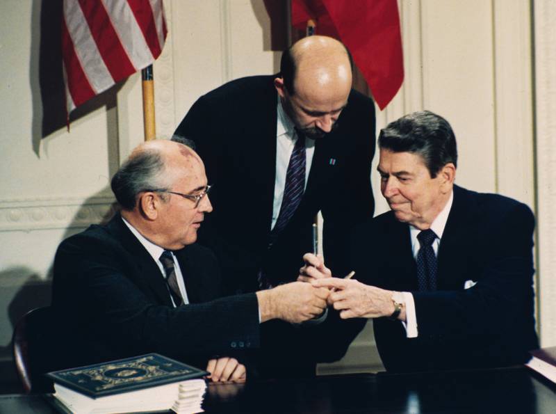 Reagan and Gorbachev exchange pens during the treaty-signing ceremony at the White House. AP