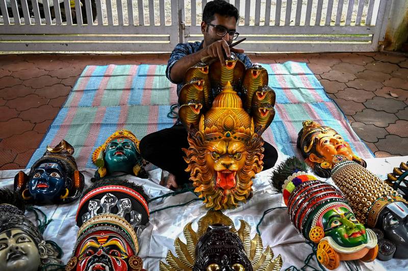An artisan prepares face masks resembling various Hindu deities for the Kummattikali, a form of colourful mask dance performed as a part of Onam celebrations in Kerala. AFP