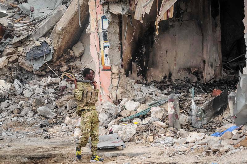 A Somali soldier patrols the scene. Mohamed Abdiwahab / AFP Photo