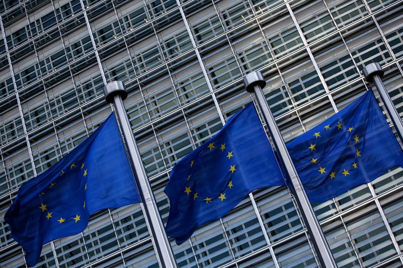 Flags of the European Union (EU) fly outside the Berlaymont building ahead of a news conference at the end of the fifth round of Brexit negotiations in Brussels, Belgium, on Thursday, Oct. 12, 2017. The European Union said scant progress has been made in the latest round of Brexit talks, increasing the chances of a messy departure as time is running out to clinch a deal. Photographer: Dario Pignatelli/Bloomberg