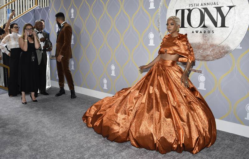 US actress Kara Young in an orange crop top and ball skirt. Invision / AP
