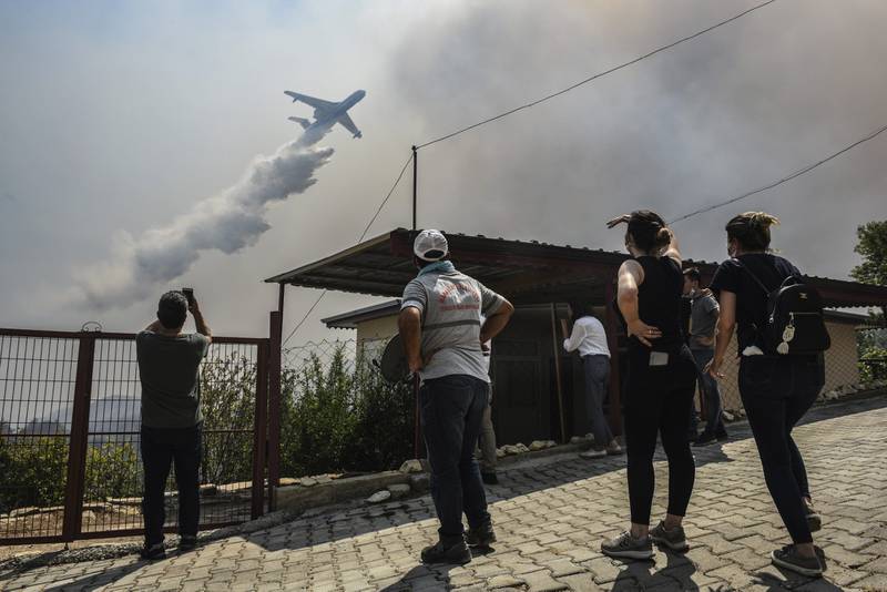 A plane pours water over Sirtkoy, a village near Manavgat, Antalya.