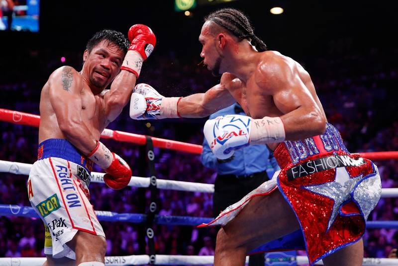 Keith Thurman, right, throws a punch against Manny Pacquiao. AP Photo