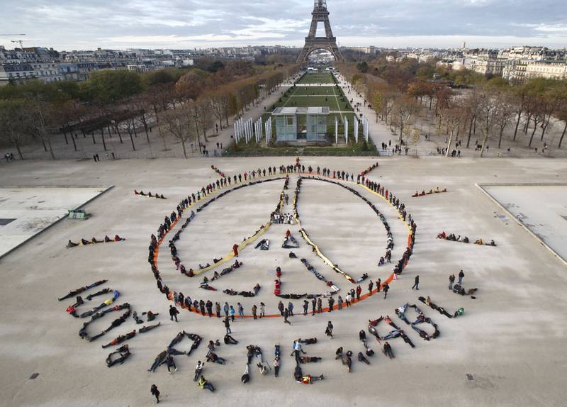 Climate activists form a human chain spelling out '100% renewable', at Cop21 in Paris in 2015. AP