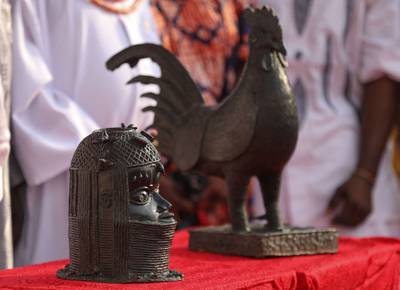 The two artefacts returned are a bronze cockerel and a bust that were looted from Nigeria more than 125 years ago. AFP