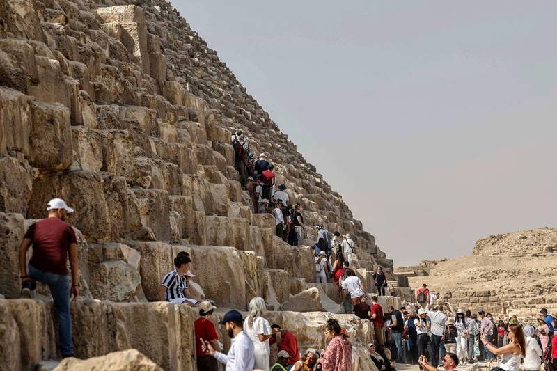 Tourists surround the Great Pyramid of Khufu (Cheops) at the Giza Pyramids necropolis. AFP