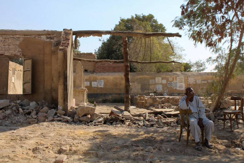 A resident of Al-Qafara, sitting outside a demolished tomb site, near his previous home. Hamza Hendawi/ The National