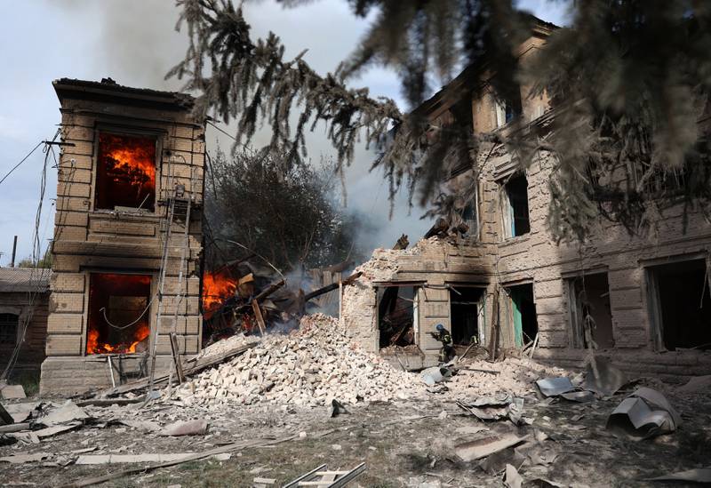 A Ukrainian firefighter extinguishes a blaze following an air strike on the town of Sloviansk, Donetsk region. AFP