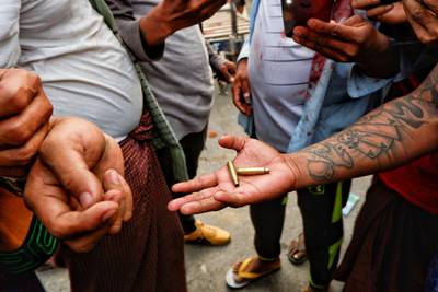 A person shows bullet shells during a protest against the military coup, in Mandalay, Myanmar. Reuters
