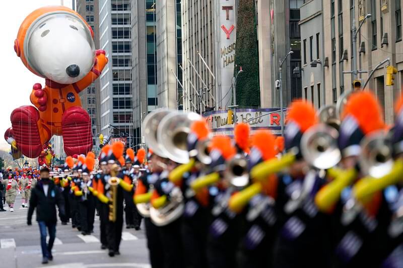 Snoopy follows a marching band. AP
