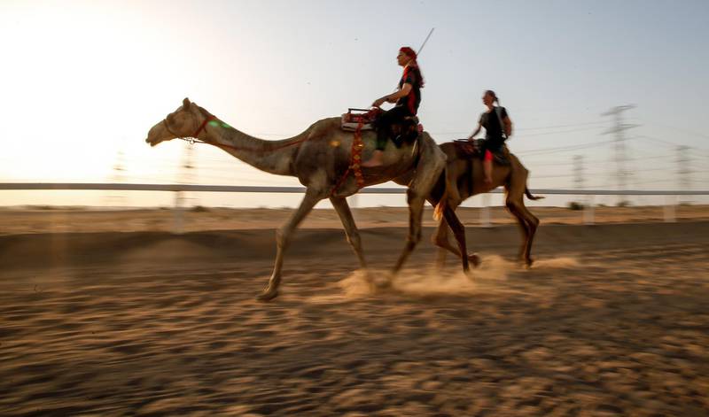 Linda Krockenberger, left, works in hospitality in Dubai but also teaches people how to ride camels. EPA