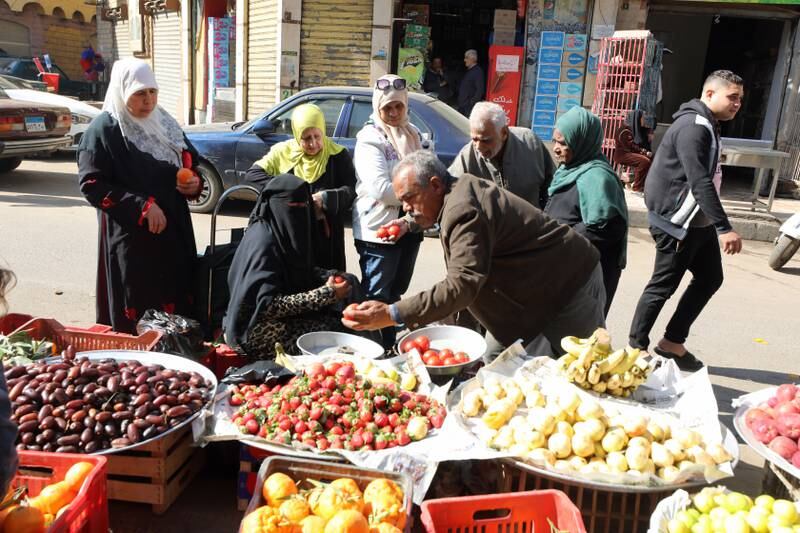 People buy fruits and vegetables at Bulaq district in Cairo. EPA