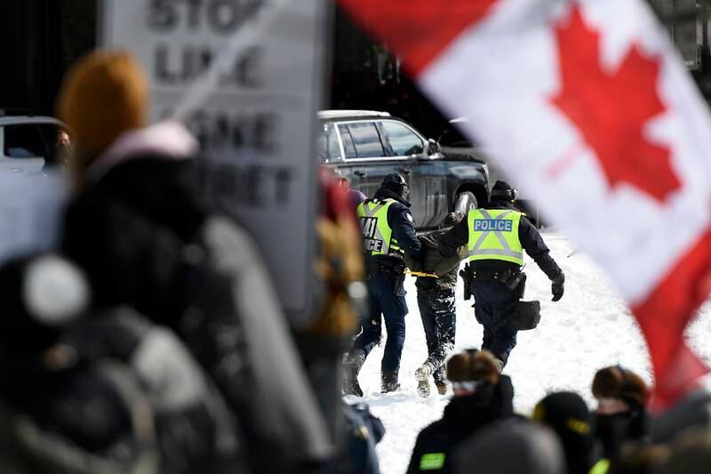 Police make an arrest as they work to bring a protest in opposition to mandatory Covid-19 vaccine mandates to an end in Ottawa on Friday. AP Photo