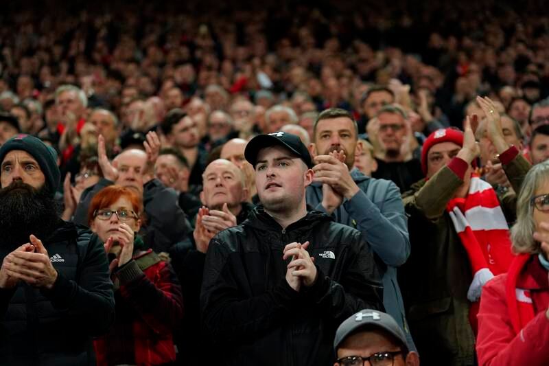 Liverpool fans applaud in the seventh minute in support for Manchester United's Cristiano Ronaldo and his family. AP