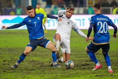 Israel defender Miguel Vitor, centre, fights for the ball with Kosovo midfielders Milot Rashica and Meriton Korenic. AFP