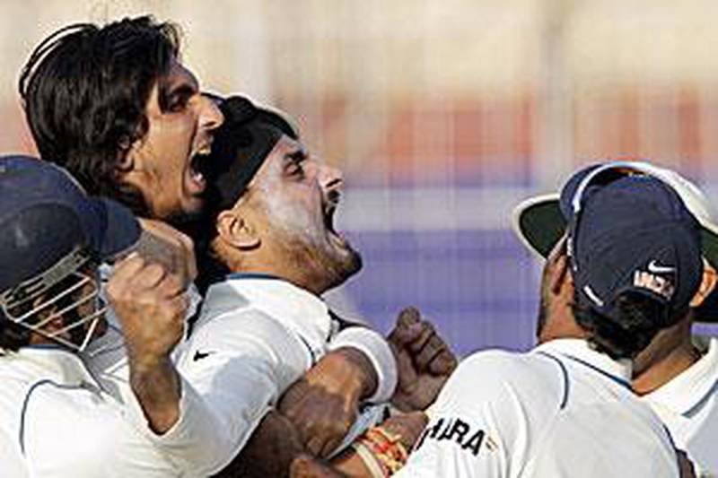A jubilant Harbhajan Singh rejoices with his teammates after the fall of Mornie Morkel's wicket with minutes left for day's play to end.
