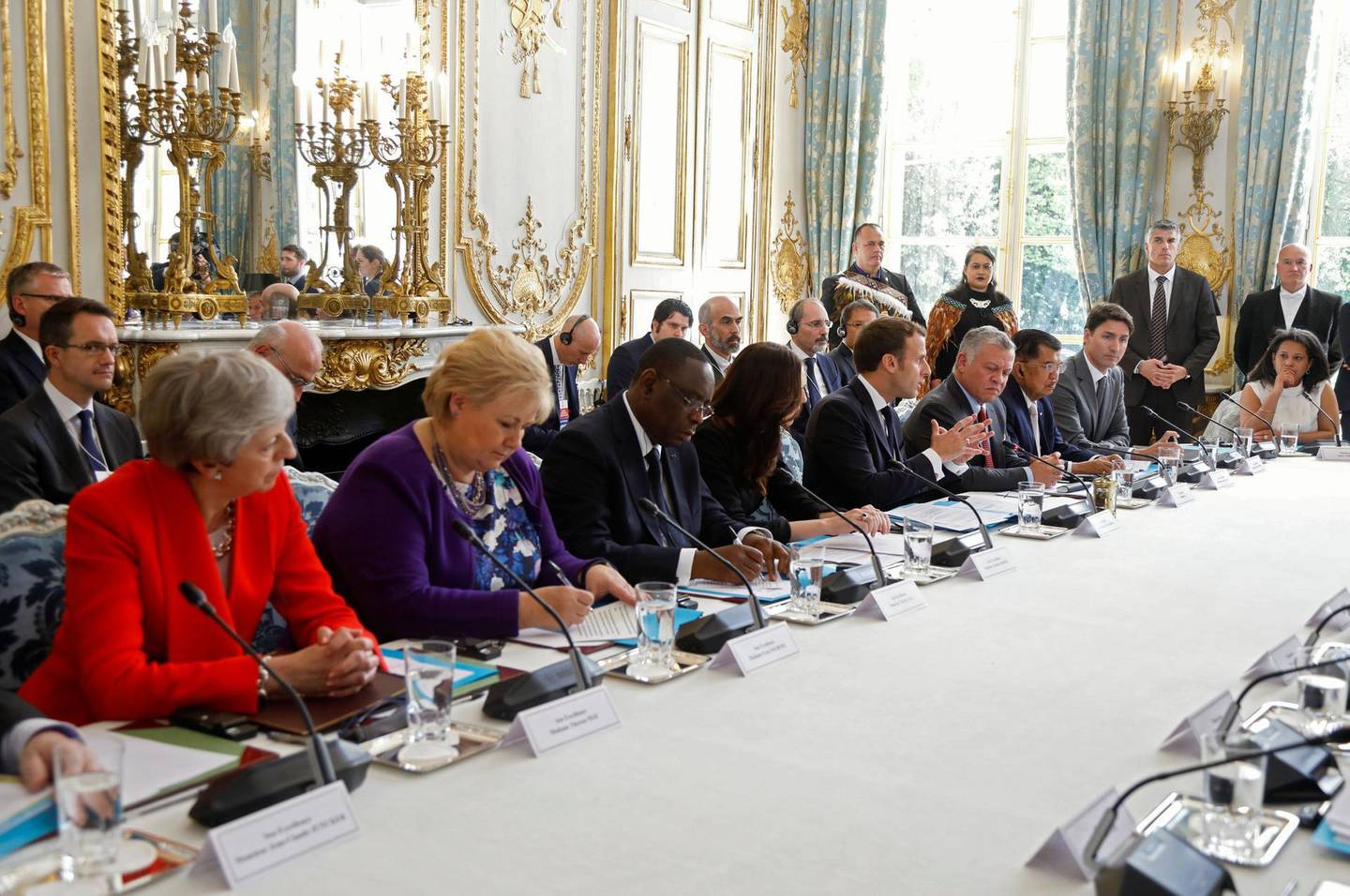 (From L) Britain's Prime Minister Theresa May, Norway's Prime Minister Erna Solberg, Senegal's President Macky Sall, New Zealand's Prime Minister Jacinda Ardern, French President Emmanuel Macron, King Abdullah II of Jordan, Indonesia's vice-President Jusuf Kalla, Canada's Prime Minister Justin Trudeau and President of France's National Digital Council Salwa Toko attend a launching ceremony for the 'Christchurch call', an initiative pushed by Ardern after a self-described white supremacist gunned down 51 people in a massacre at two mosques in the New Zealand city in March, at the Elysee Palace in Paris, on May 15, 2019. French President and New Zealand's premier host other world leaders and leading tech chiefs to launch an ambitious new initiative aimed at curbing extremism online. The political meeting will run in parallel to an initiative launched by Macron called Tech for Good which will bring together 80 tech chiefs in Paris to find a way for new technologies to work for the common good. / AFP / X00217 / CHARLES PLATIAU
