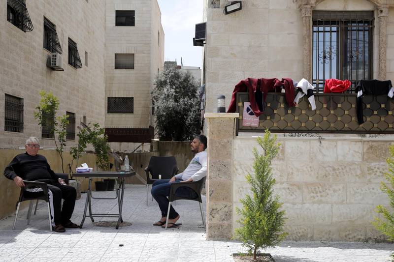 Jordanians take some fresh air at their private home terrace on another full curfew day in Amman, Jordan.  EPA