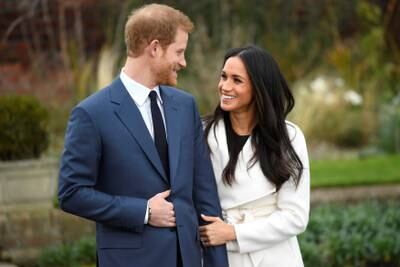Britain's Prince Harry poses with Meghan Markle in the Sunken Garden of Kensington Palace, London, Britain, November 27, 2017. REUTERS/Toby Melville