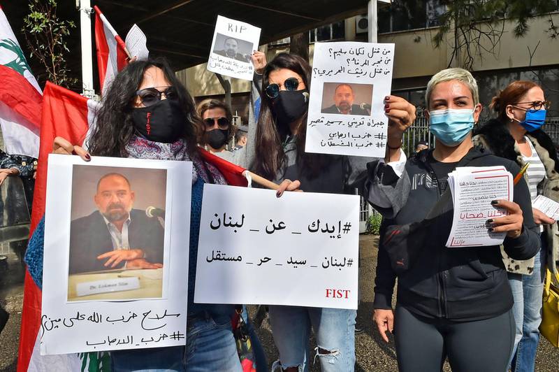 Protesters hold pictures of slain prominent Lebanese activist and intellectual Lokman Slim,  during a rally in front of the Justice Palace in the capital Beirut. AFP