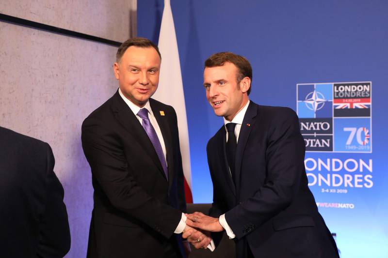 France's President Emmanuel Macron (right) greets Poland's President Andrzej Duda (left) during a meeting at the Nato summit at the Grove hotel in Watford. AFP