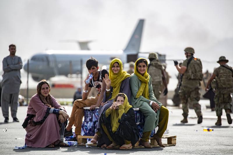 Displaced children wait for the next flight at Hamid Karzai International Airport, Kabul on August 19, 2021. AFP