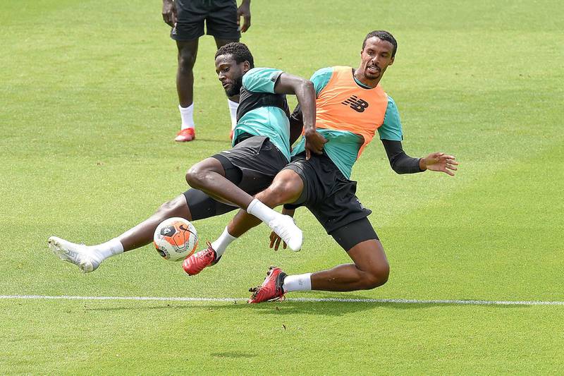 LIVERPOOL, ENGLAND - JUNE 17: (THE SUN OUT. THE SUN ON SUNDAY OUT) Divock Origi of Liverpool with Joel Matip of Liverpool during a training session at Melwood Training Ground on June 17, 2020 in Liverpool, England. (Photo by John Powell/Liverpool FC via Getty Images)