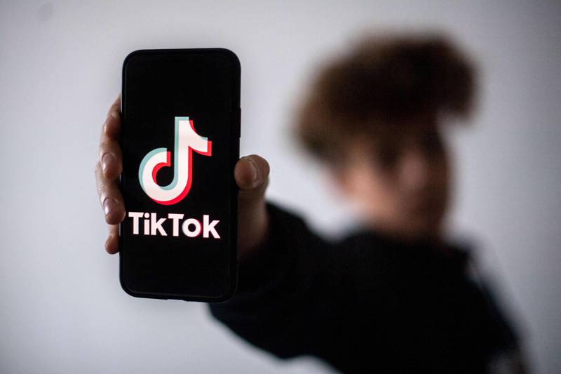 The clock is ticking … a youth with the TikTok logo.  AFP