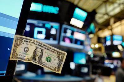 The dollar is making gains, expected to end the week on a yearly high. Mark Lennihan / AP