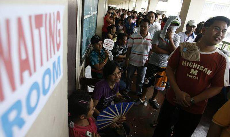 Voters wait their turn at a polling station in Manila yesterday. Problems with some voting machines resulted in inordinate delays. Cheryl Ravelo / Reuters