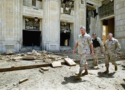 Gen Tommy Franks (c) visits a palace of Saddam Hussein in Baghdad on April 16, 2003. Getty Images