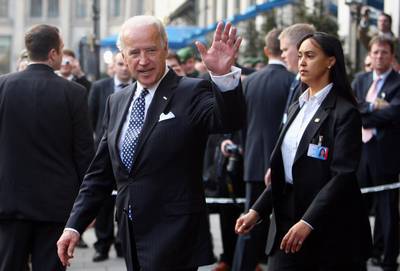 MUNICH, GERMANY - FEBRUARY 07: U.S. Vice President Joseph Biden waves to journalists as he leaves the Bayerischer Hof hotel, the venue of the Munich Security Conference, during the second day of the Munich conference on security policy on February 7, 2009 in Munich, Germany. The 45th Munich conference on security policy is running from February 6 to 8, 2009.  (Photo by Miguel Villagran/Getty Images)