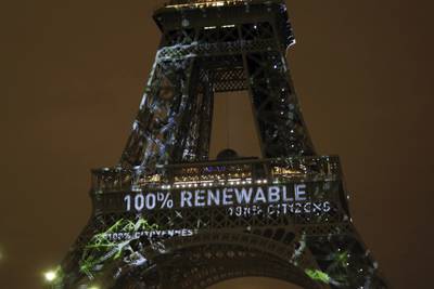 An artwork entitled 'One Heart One Tree' by Naziha Mestaoui is displayed on the Eiffel Tower before the 2015 Paris climate conference. AP Photo