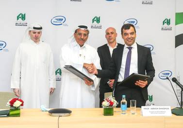 Khalaf Ahmad Al Habtoor (second from left), founding chairman of Al Habtoor Group, shaking hand with Amnon Shashua, chief executive of Mobileye, after signing the pact. Courtesy Al Habtoor Group