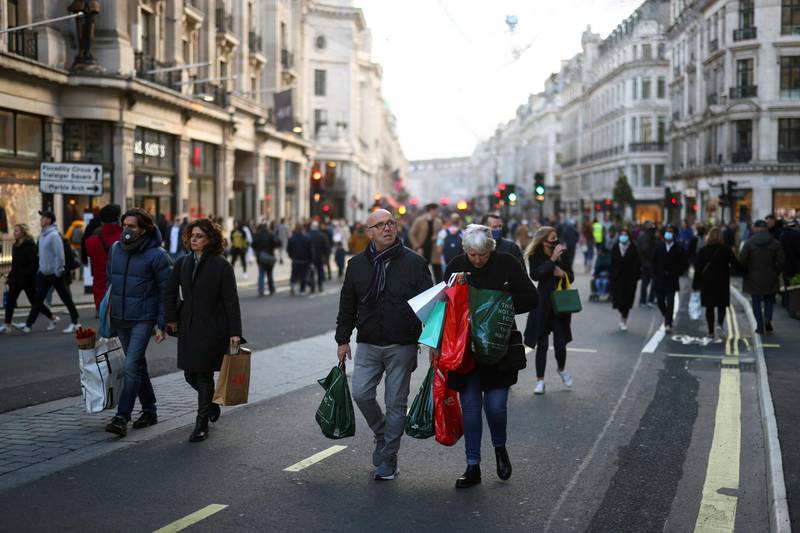 Shoppers walk down pedestrianized Regent Street. Reuters