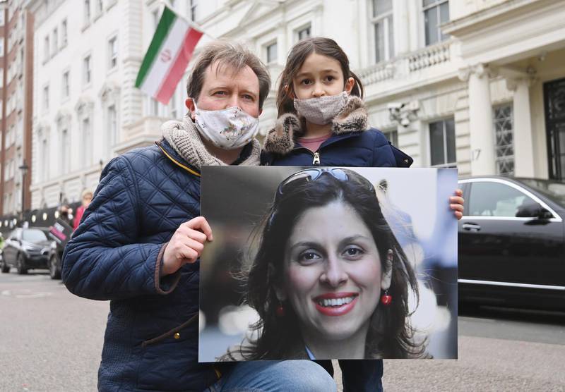 Richard Ratcliffe, the husband of Nazanin Zaghari-Ratcliffe, with his daughter Gabriella pose for photographers during a protest outside the Iranian Embassy in London. EPA