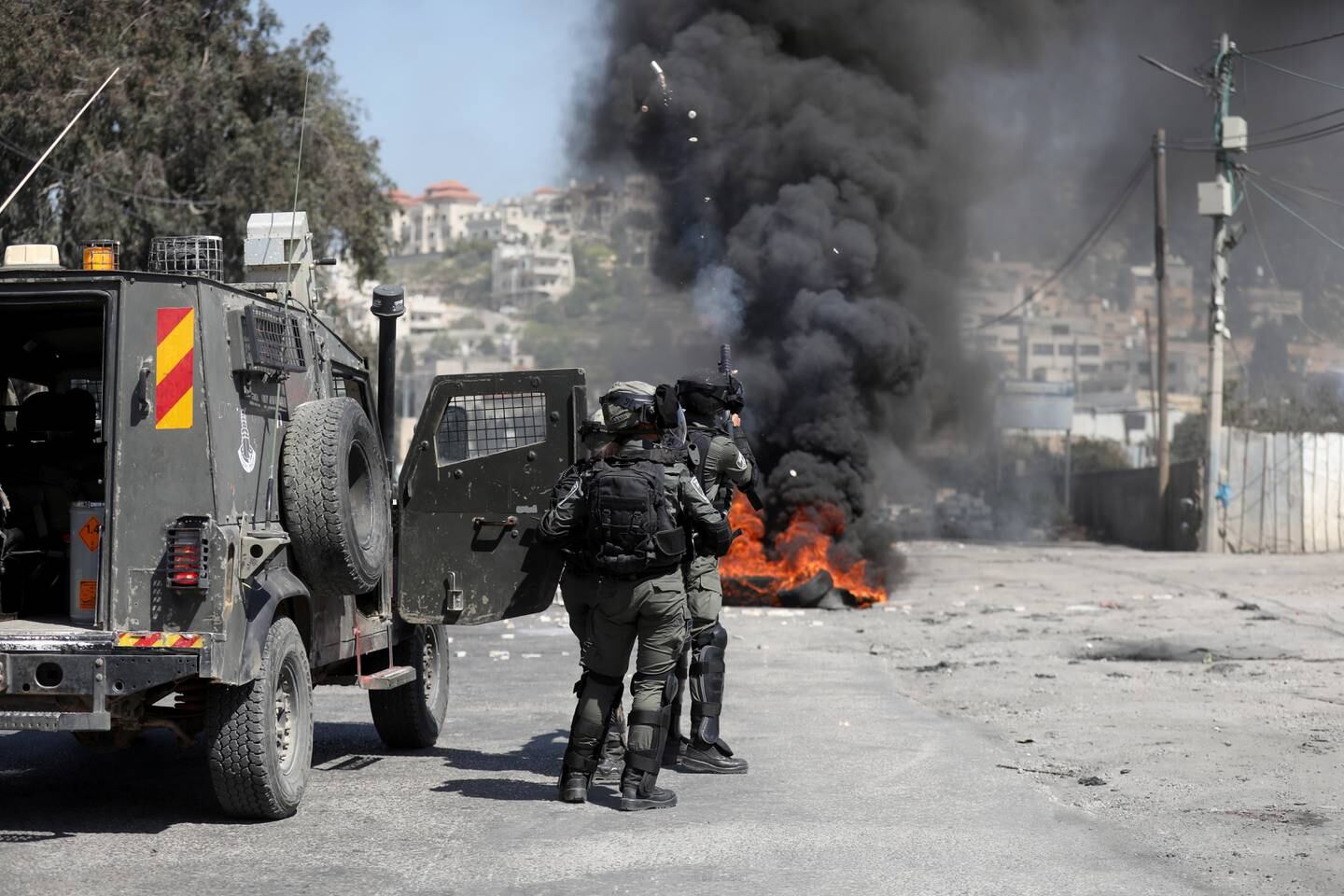 Israeli soldiers fire tear gas at Palestinians during clashes in Beita. EPA