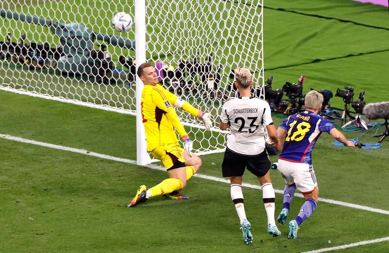 Takuma Asano (R) of Japan scores the second goal of his team against German goalkeeper Manuel Neuer. EPA